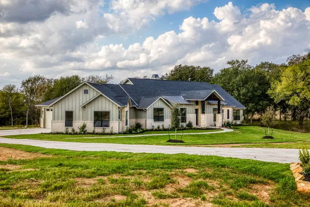 a swimming pool with outdoor seating and yard