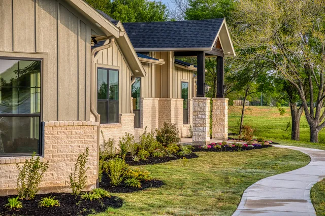 a view of a house with yard and a garden