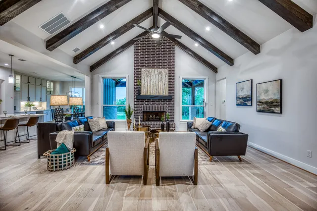 a living room with fireplace furniture and a wooden floor