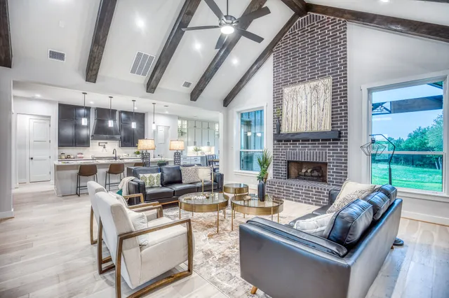 a living room with furniture fireplace and a large window