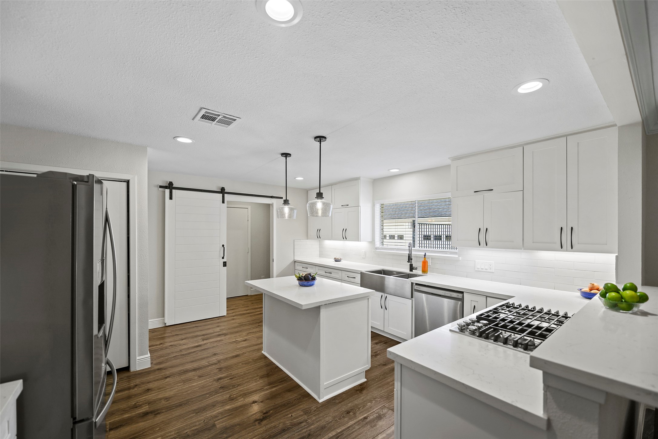 4419 Langtry Lane Houston, TX 77041 - Photo 23 of 50 a kitchen with white cabinets and stainless steel appliances