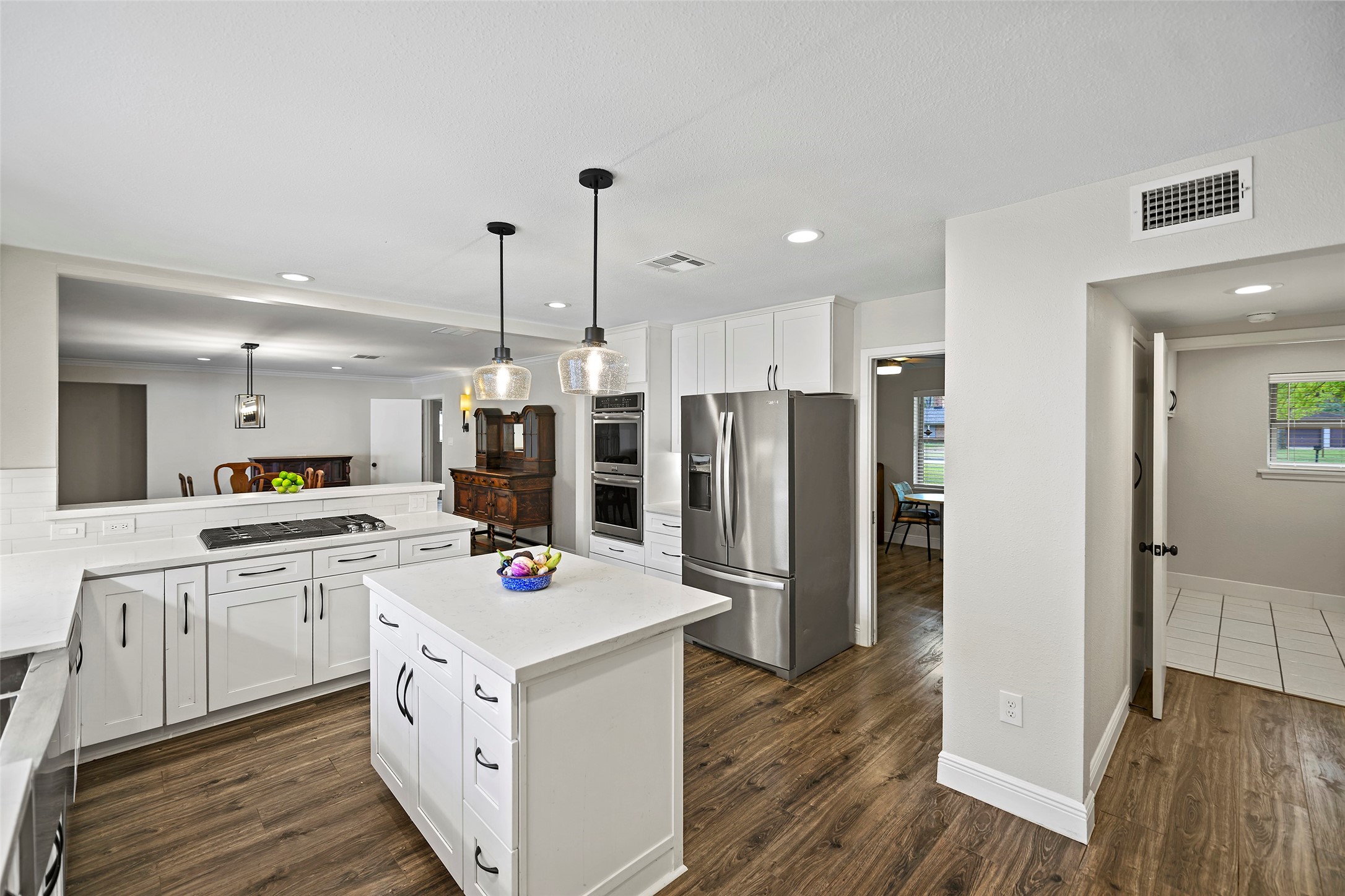 4419 Langtry Lane Houston, TX 77041 - Photo 24 of 50 a large kitchen with stainless steel appliances a stove a refrigerator a oven and white cabinets with wooden floor