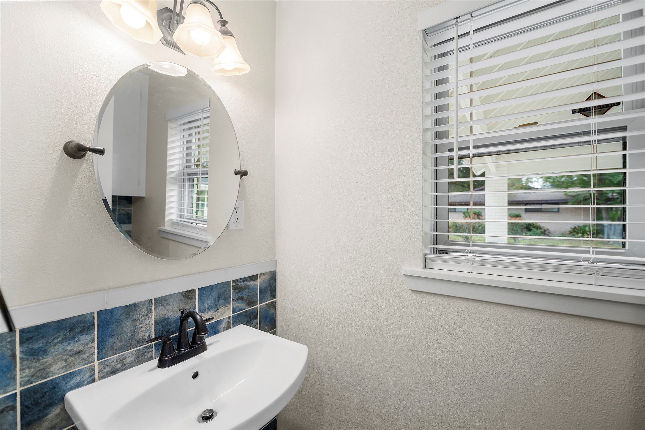4419 Langtry Lane Houston, TX 77041 - Photo 30 of 50 a bathroom with a sink and a mirror