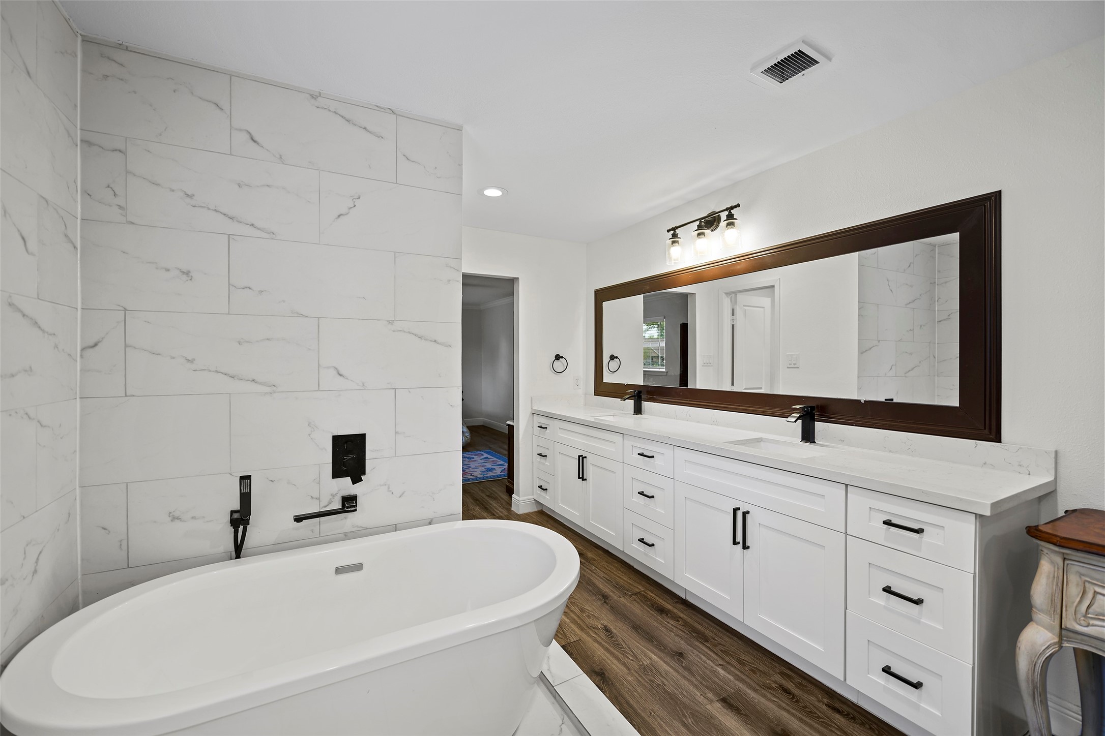 4419 Langtry Lane Houston, TX 77041 - Photo 8 of 50 a bathroom with a bathtub and a double vanity sink