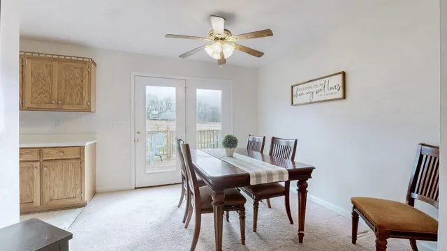 a view of a dining room with furniture and a chandelier