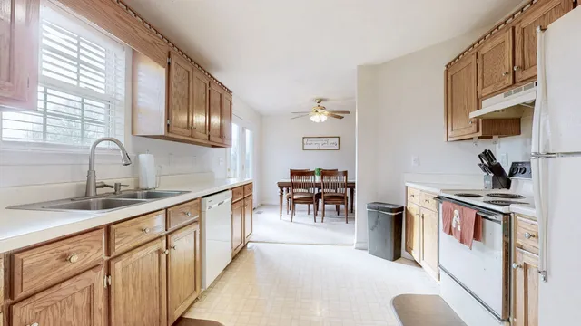 a kitchen with furniture a sink and a stove