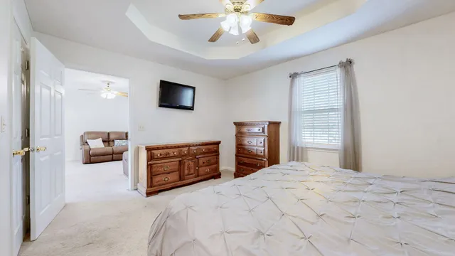 a bedroom with a bed and a television