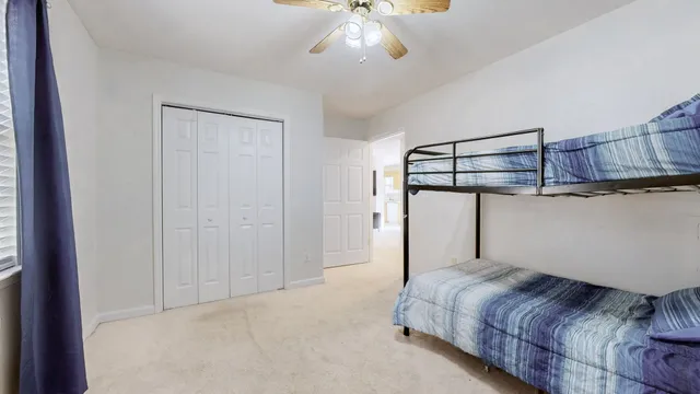 a bedroom with a bed and cabinets