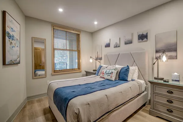 a bedroom with a large bed and a window