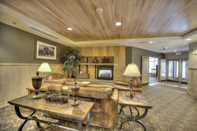 a living room with fireplace furniture and a wooden floor