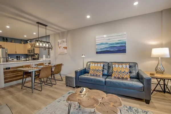 a living room with furniture and kitchen view