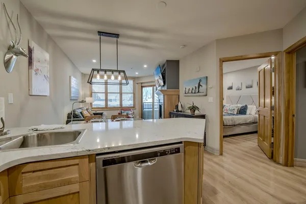 a kitchen with counter top space and wooden floor