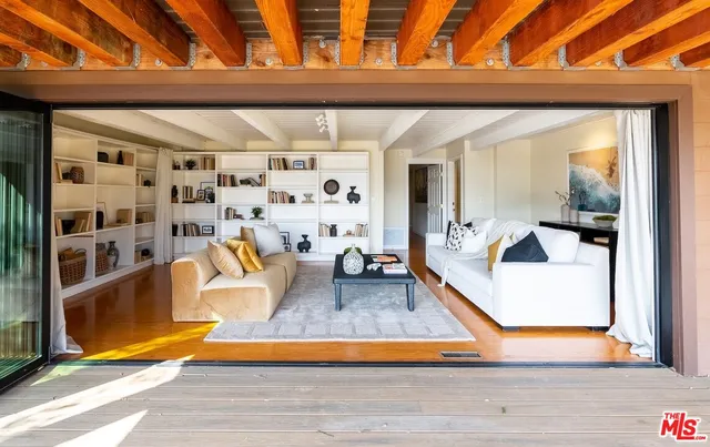 a living room with furniture and a book shelf