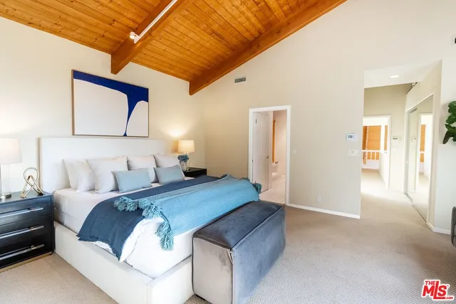 a bedroom with a bed and wall painting