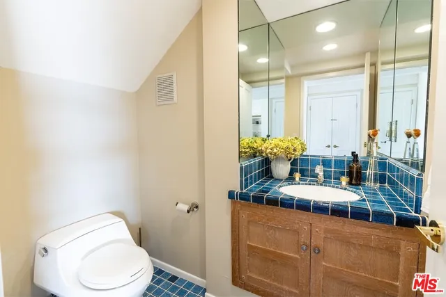 a bathroom with a toilet sink and mirror