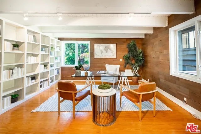a dining room with furniture and a rug
