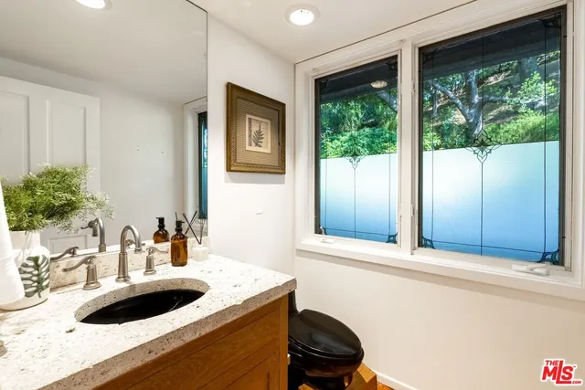 a bathroom with a sink and a window