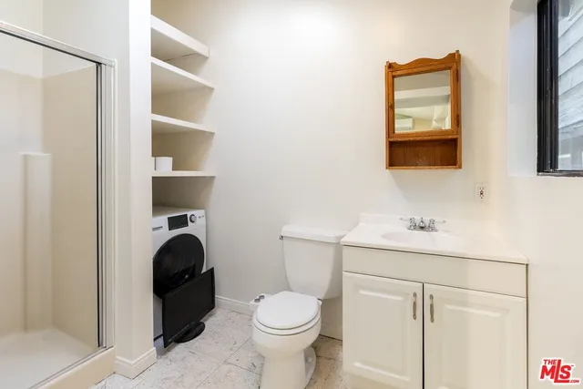 a bathroom with a toilet sink a vanity and mirror