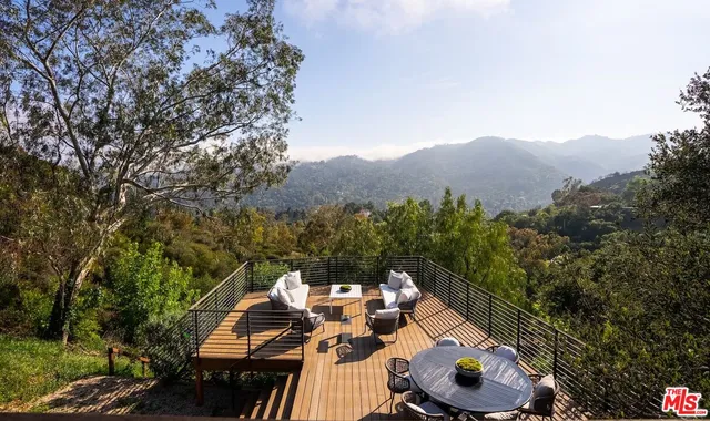 a view of a balcony with two chairs and a stove