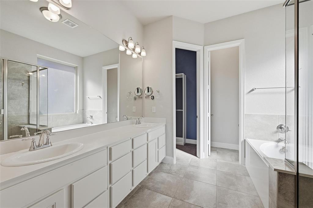 2013 Historic District Aubrey, TX 76227 - Photo 13 of 25 a spacious bathroom with a double vanity sink shower and a mirror