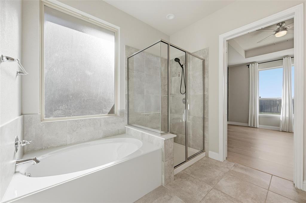 2013 Historic District Aubrey, TX 76227 - Photo 14 of 25 a bathroom with a bathtub and a shower
