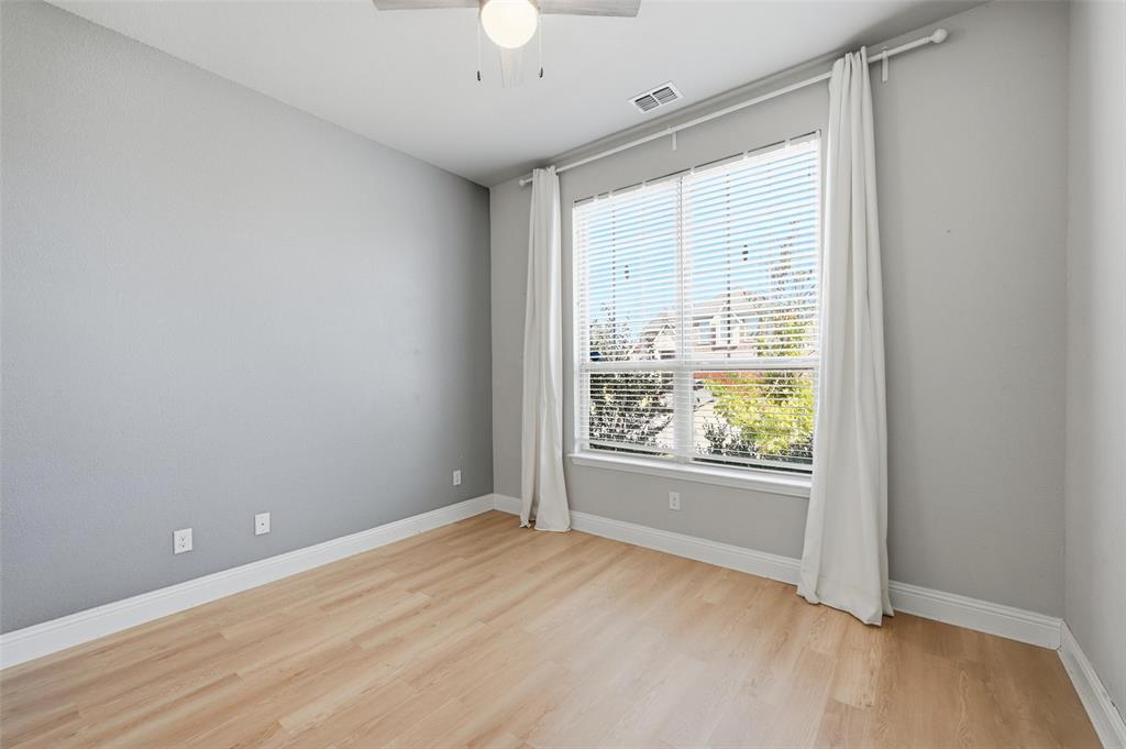 2013 Historic District Aubrey, TX 76227 - Photo 2 of 25 an empty room with wooden floor and windows