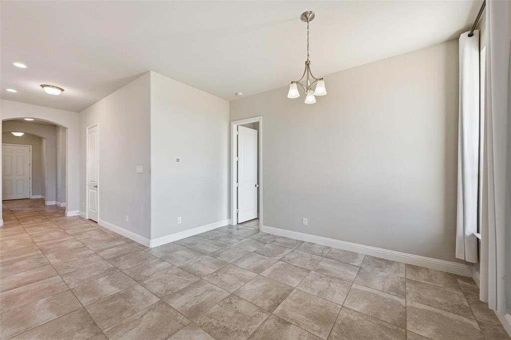 2013 Historic District Aubrey, TX 76227 - Photo 9 of 25 a view of an empty room with a chandelier fan