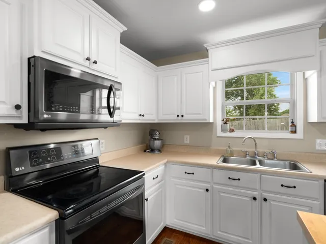 a view of a dining room with furniture a chandelier and wooden floor