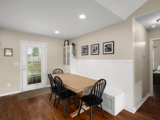 a view of a dining room with furniture and wooden floor