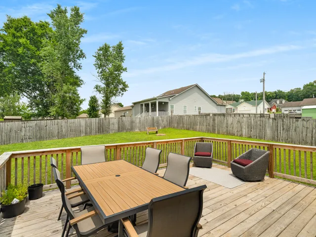 a view of a chair and table on the deck