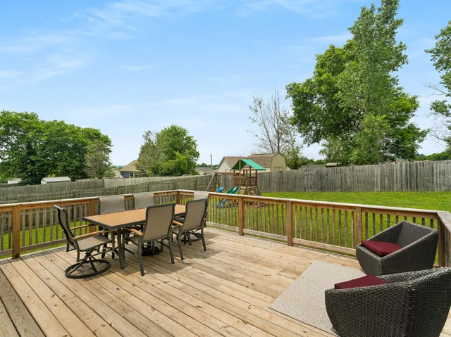 a view of a house with a yard table and chairs