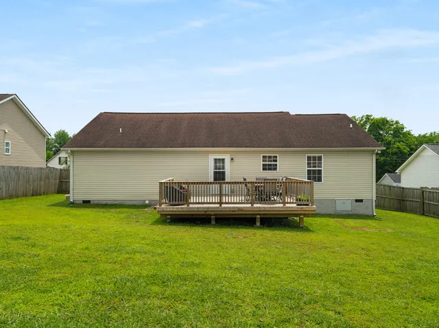 a view of a house with a big yard and sitting area