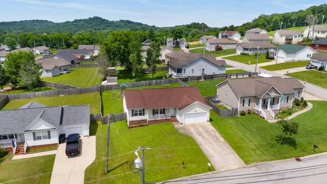 an aerial view of residential houses with outdoor space and swimming pool