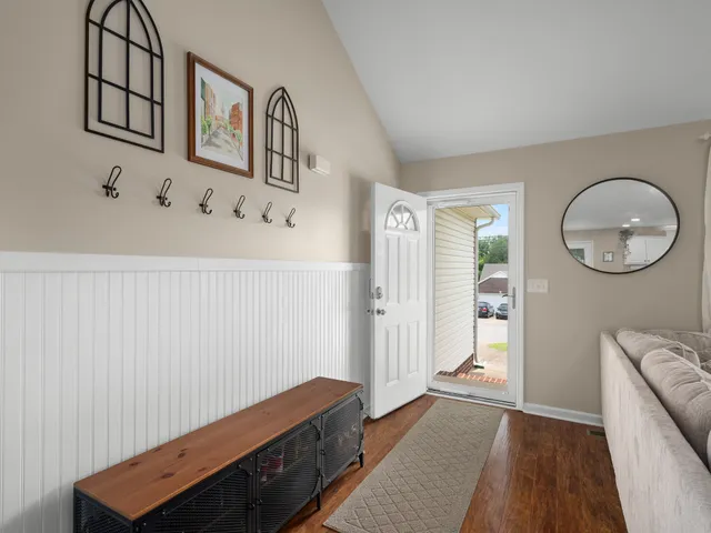 a kitchen with stainless steel appliances granite countertop a kitchen island a stove a table and a refrigerator