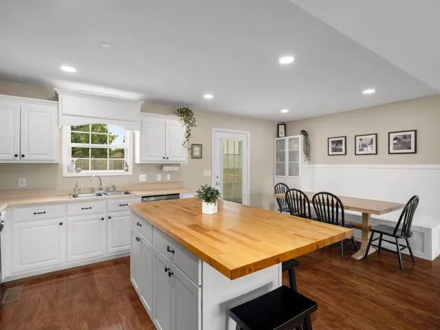a kitchen with a sink stove top oven and microwave