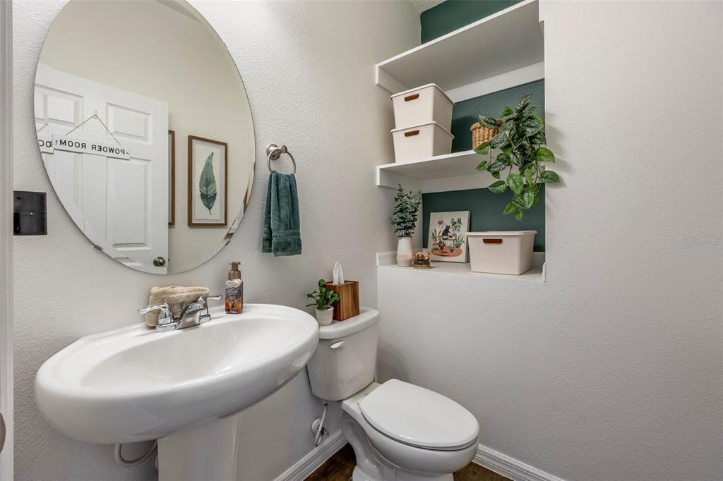 15448 Blackbead Street Winter Garden, FL 34787 - Photo 11 of 28 a bathroom with a toilet sink and mirror