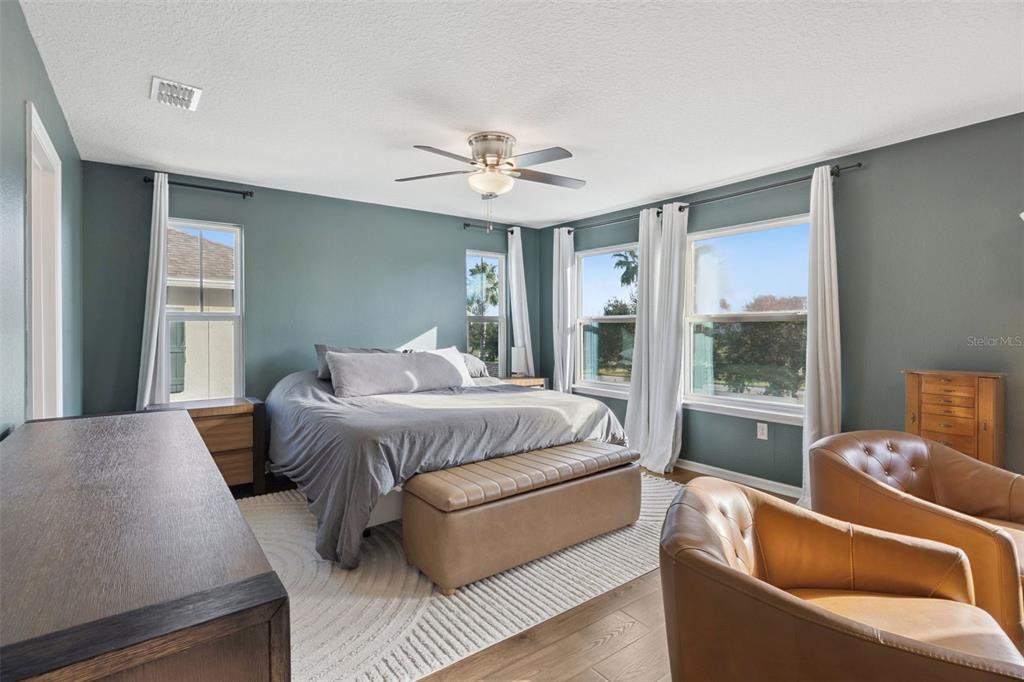 15448 Blackbead Street Winter Garden, FL 34787 - Photo 13 of 28 a bedroom with bed couch and window