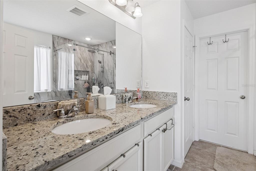 15448 Blackbead Street Winter Garden, FL 34787 - Photo 14 of 28 a bathroom with a granite countertop sink and a mirror