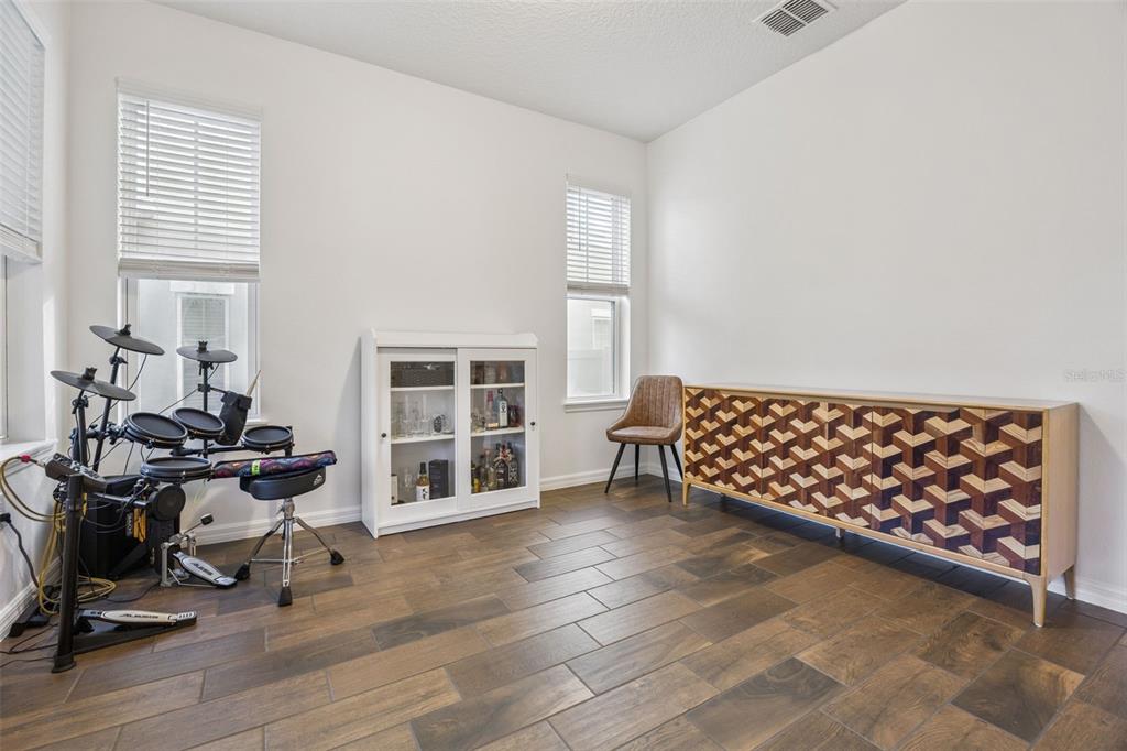 15448 Blackbead Street Winter Garden, FL 34787 - Photo 4 of 28 a bedroom with furniture and wooden floor