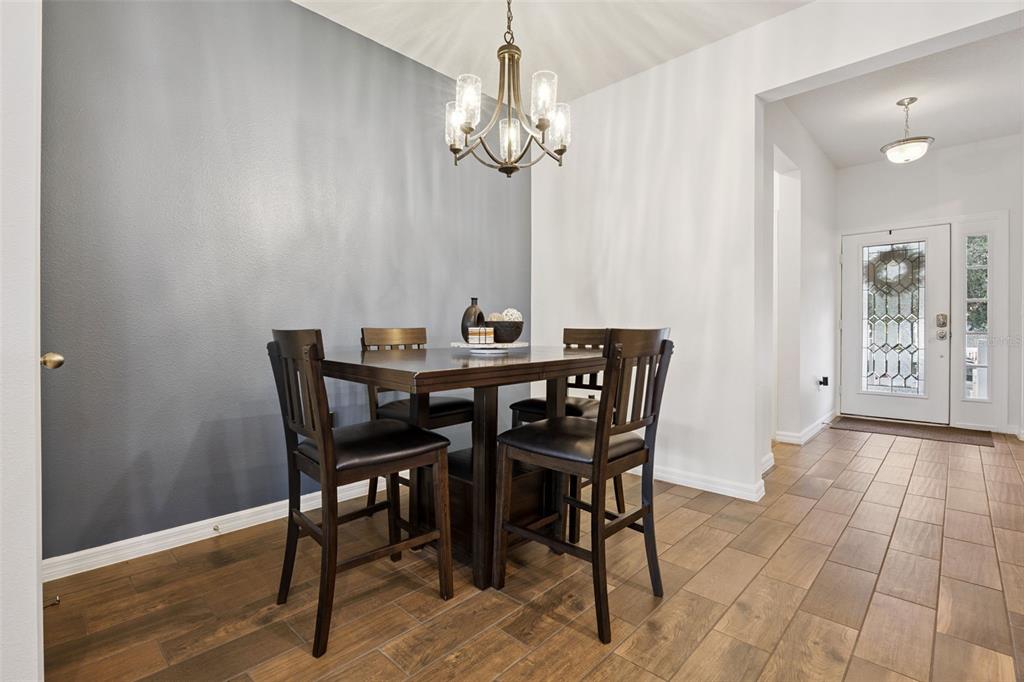 15448 Blackbead Street Winter Garden, FL 34787 - Photo 7 of 28 a view of a dining room with furniture and chandelier