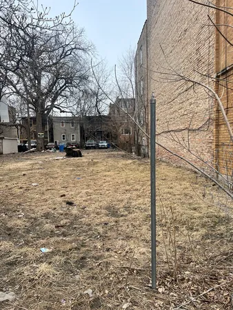 a view of a yard with snow on the wall