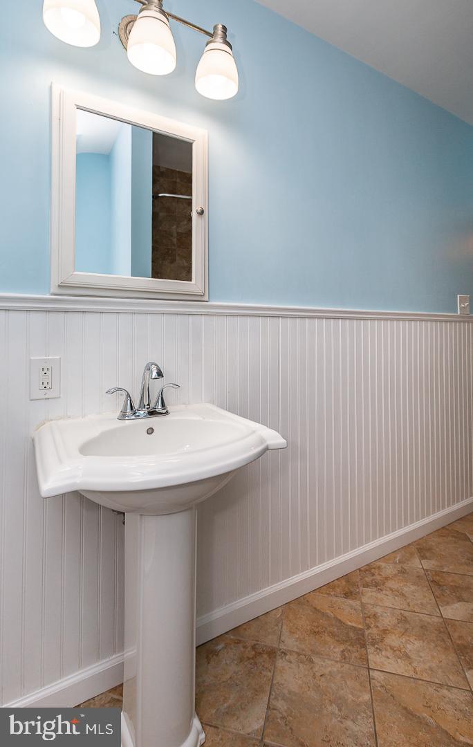 6609 Morris Park Road Philadelphia, PA 19151 - Photo 24 of 35 a bathroom with a sink and a mirror