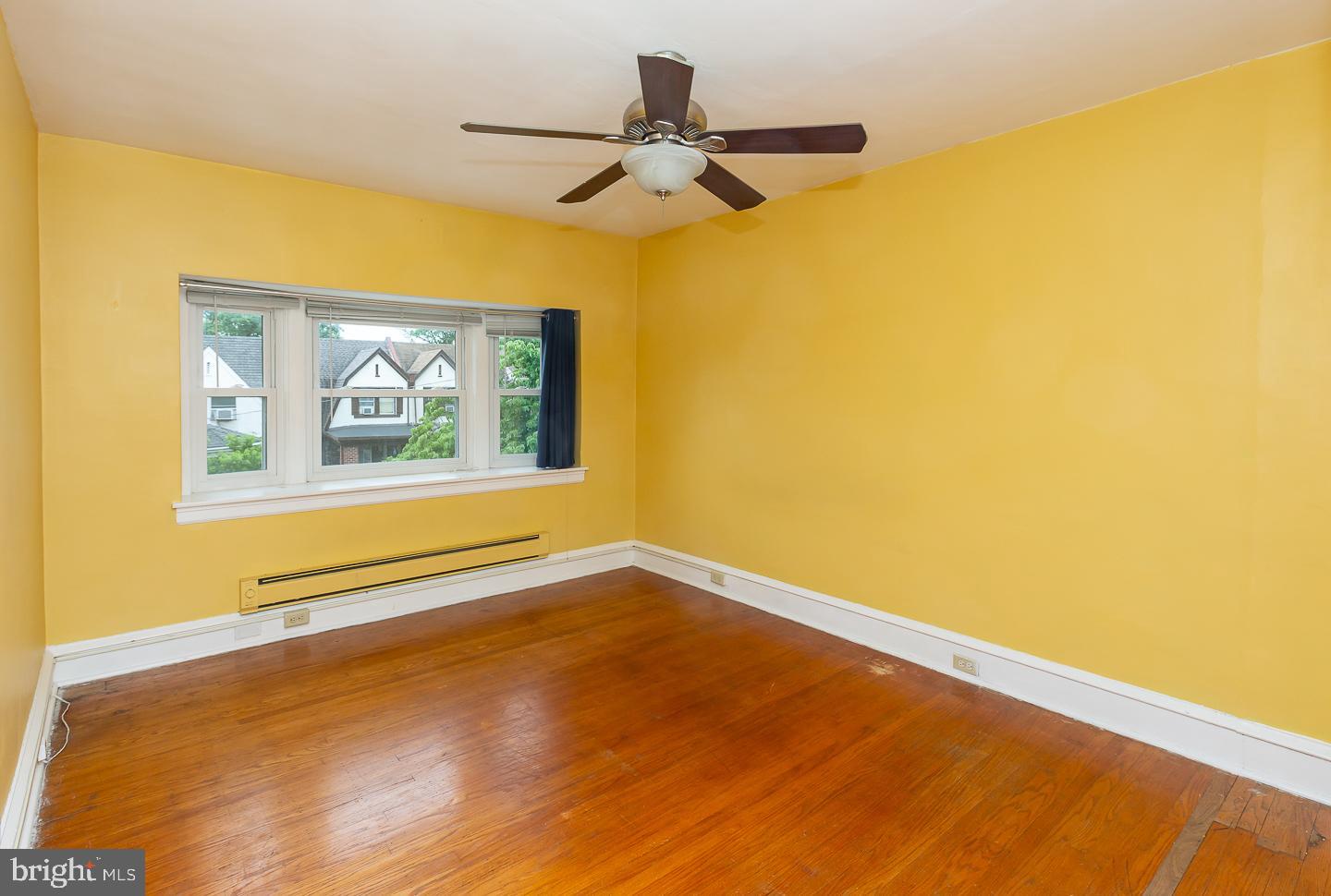 6609 Morris Park Road Philadelphia, PA 19151 - Photo 28 of 35 a view of a big room with wooden floor and a ceiling fan
