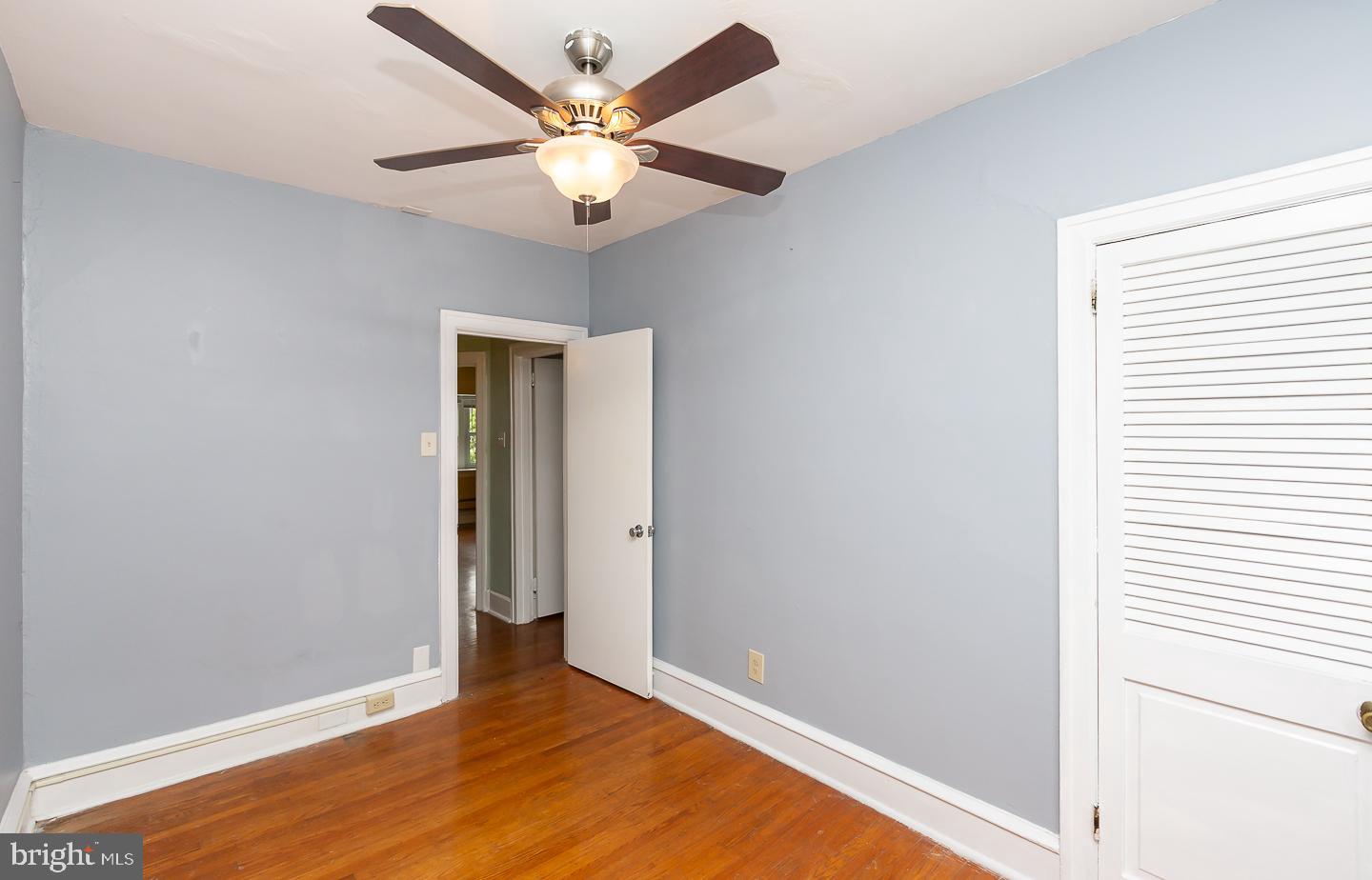 6609 Morris Park Road Philadelphia, PA 19151 - Photo 33 of 35 an empty room with closet and wooden floor