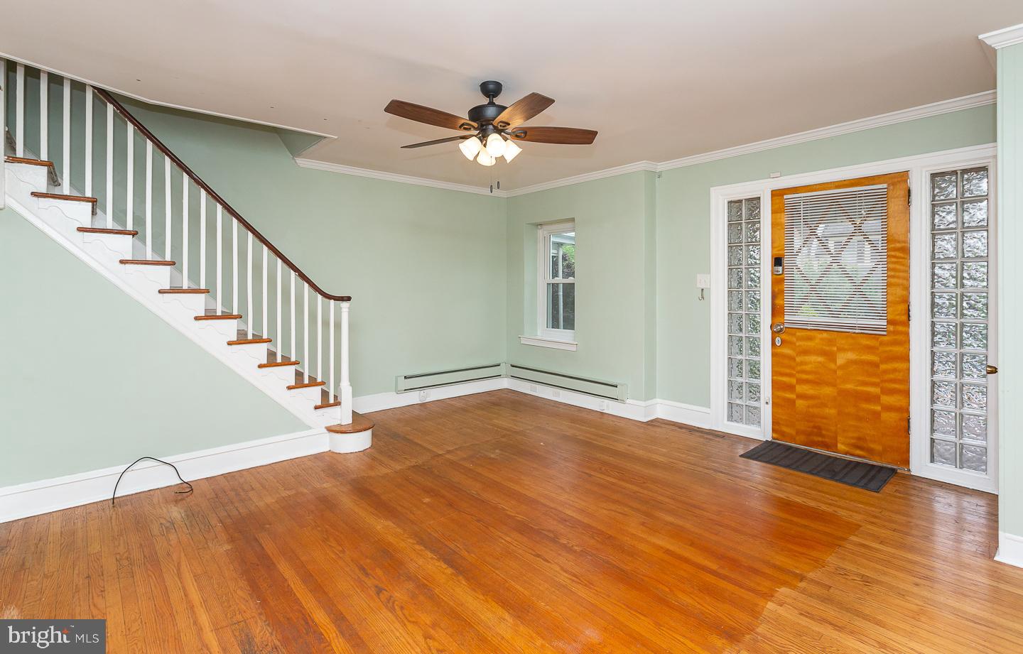 6609 Morris Park Road Philadelphia, PA 19151 - Photo 6 of 35 a view of an empty room with wooden floor and a ceiling fan