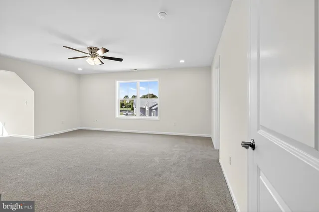 a view of a livingroom with a ceiling fan and window