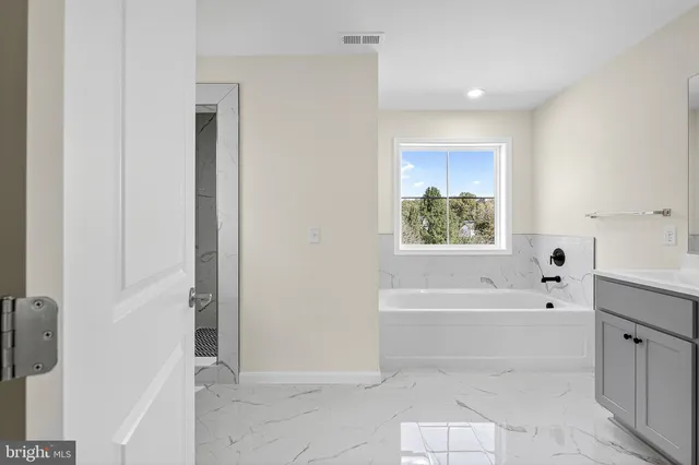 a bathroom with a bathtub and a shower
