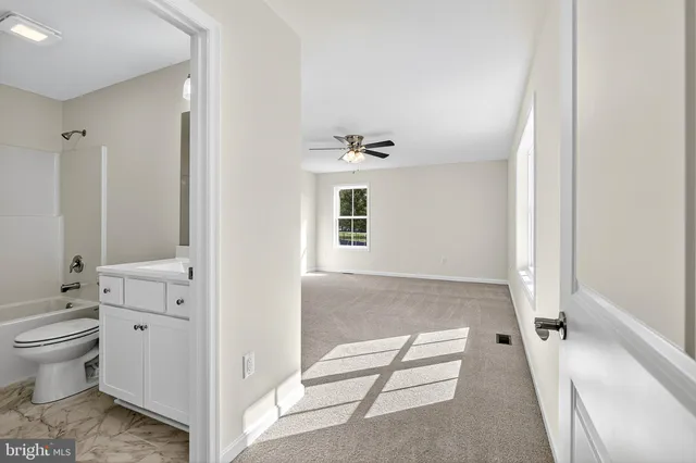 a view of bathroom with a toilet a shower and a sink