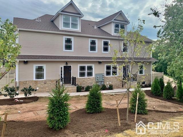 144 Harding Avenue, Unit 2 Edison, NJ 08820 - Photo 2 of 12 a front view of a house with garden