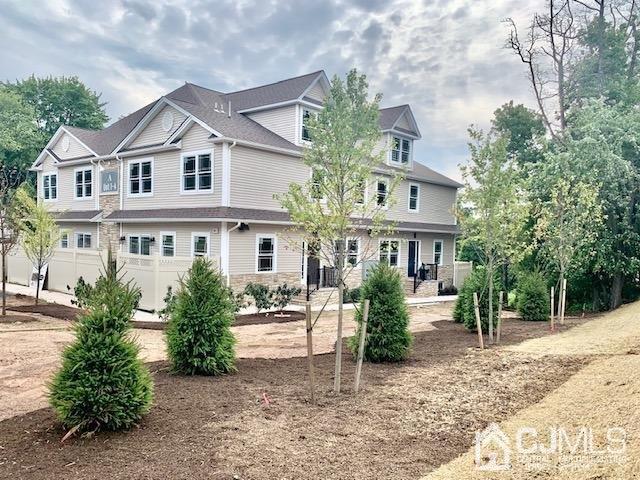 144 Harding Avenue, Unit 2 Edison, NJ 08820 - Photo 5 of 12 a front view of a residential houses with yard and green space